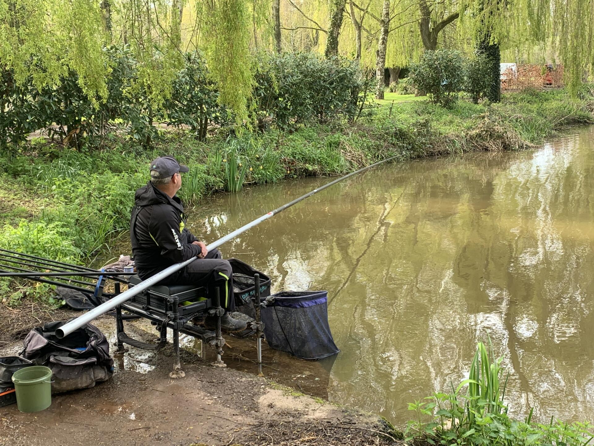 Pole fishing on a lake in spring