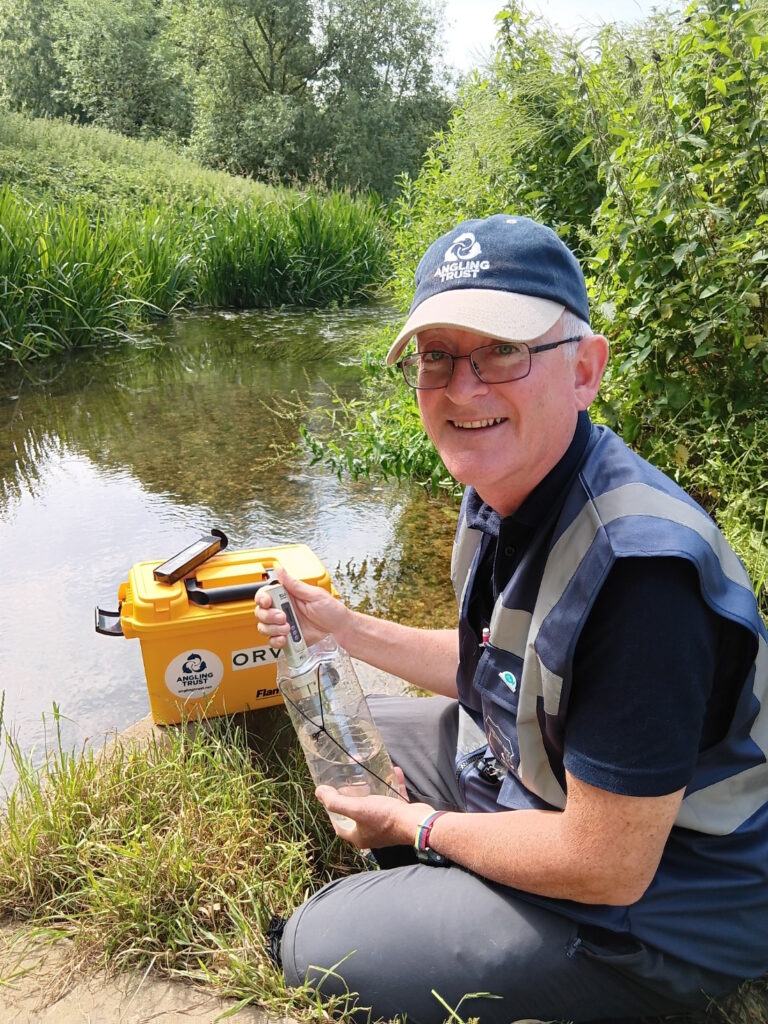 Jonathan Swan takes the 2000th water quality sample as part of the 'Anglers Against Pollution' campaign