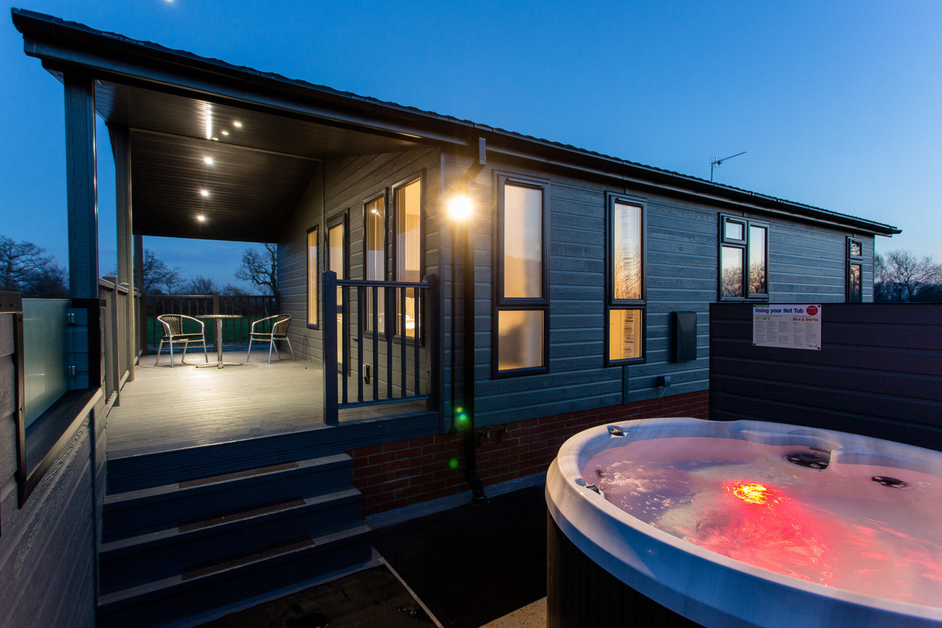 A Willow Lodge and hot tub at High Lodge Leisure and Fishery in Suffolk